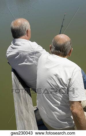 Rear view of two senior men fishing View Large Photo Image Stock Image - Rear view of two senior men fishing. Fotosearch