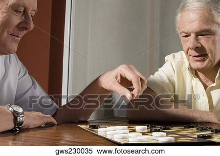 Stock Photography - Two senior men playing checkers. Fotosearch