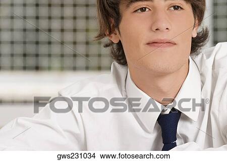 Close-up of a young man in a classroom View Large Photo Image Picture - Close-up of a young man in a classroom. Fotosearch