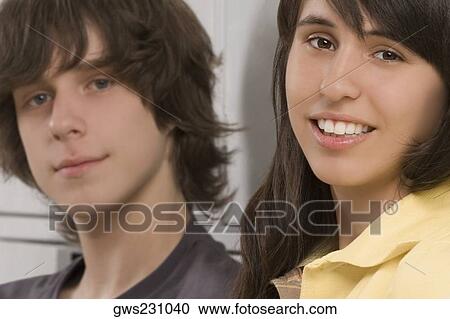 Portrait of a teenage boy and a teenage girl smiling View Large Photo Image Stock Image - Portrait of a teenage boy and a teenage girl smiling. Fotosearch
