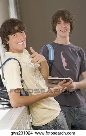 Picture - Portrait of a teenage boy and a young man smiling together. Fotosearch