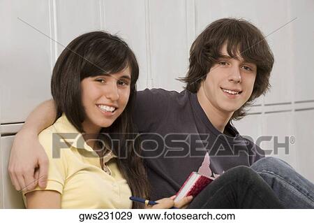 Portrait of a teenage boy arm around with a teenage girl and smiling View Large Photo Image Stock Photo - Portrait of a teenage boy arm around with a teenage girl and smiling. Fotosearch