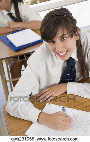 Portrait of a teenage girl smiling in a classroom View Large Photo Image Stock Photography - Portrait of a teenage girl smiling in a classroom. Fotosearch