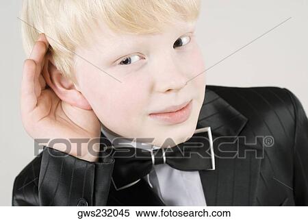 Close-up of a boy covering his ears with his hands View Large Photo Image Stock Photography - Close-up of a boy covering his ears with his hands. Fotosearch