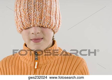 Close-up of a boy hiding his face with a knit hat View Large Photo Image Picture - Close-up of a boy hiding his face with a knit hat. Fotosearch