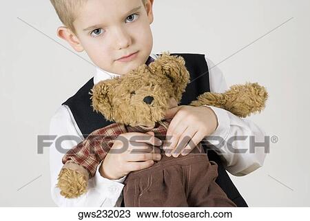 Close-up of a boy holding a teddy bear View Large Photo Image Stock Image - Close-up of a boy holding a teddy bear. Fotosearch