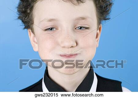 Stock Photography - Close-up of a boy making a face. Fotosearch