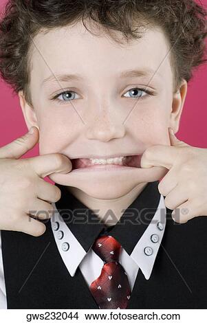 Close-up of a boy pulling his lips corners View Large Photo Image Picture - Close-up of a boy pulling his lips corners. Fotosearch