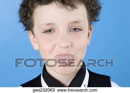 Close-up of a boy sticking its tongue out View Large Photo Image Stock Image - Close-up of a boy sticking its tongue out. Fotosearch