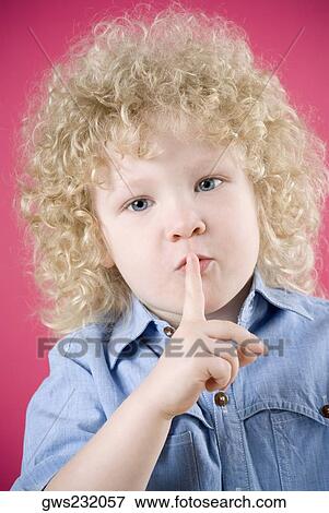 Close-up of a boy with his finger on his lips View Large Photo Image Stock Photo - Close-up of a boy with his finger on his lips. Fotosearch