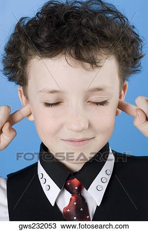 Close-up of a boy with his fingers in his ears View Large Photo Image Stock Image - Close-up of a boy with his fingers in his ears. Fotosearch