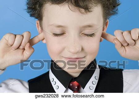Close-up of a boy with his fingers in his ears View Large Photo Image Stock Photo - Close-up of a boy with his fingers in his ears. Fotosearch