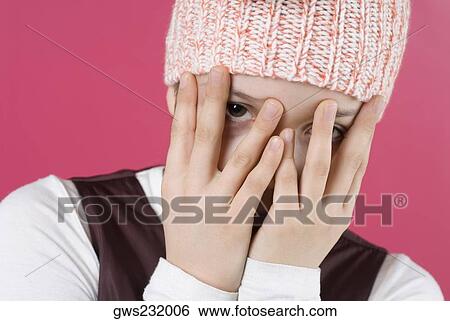 Close-up of a girl hiding her face with her hands View Large Photo Image Stock Photograph - Close-up of a girl hiding her face with her hands. Fotosearch