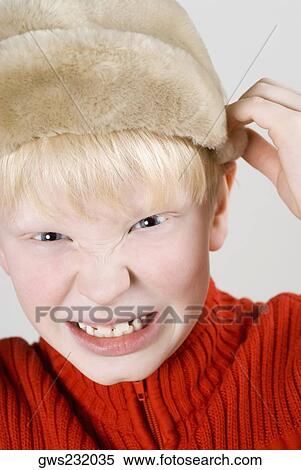 Portrait of a boy pulling his cap View Large Photo Image Stock Photography - Portrait of a boy pulling his cap. Fotosearch