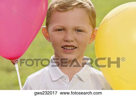 Stock Photo - Portrait of a boy with balloons. Fotosearch