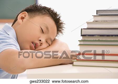 Close-up of a schoolboy napping in a classroom View Large Photo Image Stock Image - Close-up of a schoolboy napping in a classroom. Fotosearch