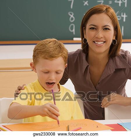 Female teacher helping her student in drawing View Large Photo Image Stock Photo - Female teacher helping her student in drawing. Fotosearch