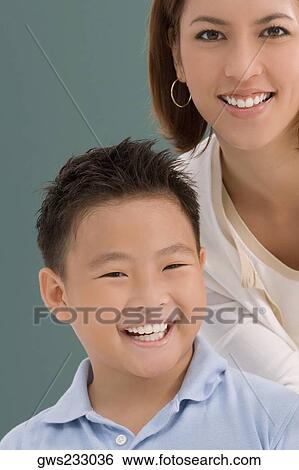 Portrait of a schoolboy with his female teacher smiling together in a classroom View Large Photo Image Stock Photograph - Portrait of a schoolboy with his female teacher smiling together in a classroom. Fotosearch