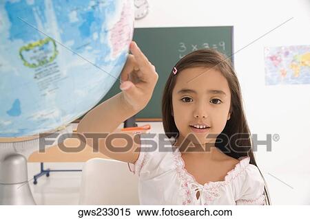 Portrait of a schoolgirl pointing on a globe View Large Photo Image Stock Photography - Portrait of a schoolgirl pointing on a globe. Fotosearch
