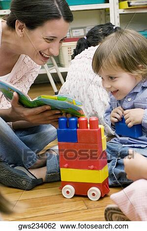 Female teacher teaching her student in a classroom View Large Photo Image Stock Image - Female teacher teaching her student in a classroom. Fotosearch