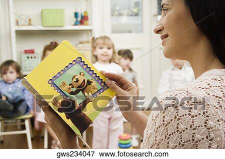 Female teacher teaching her students in a classroom View Large Photo Image Stock Photo - Female teacher teaching her students in a classroom. Fotosearch
