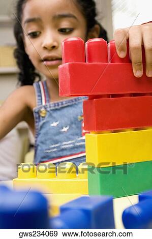 Girl playing with plastic blocks View Large Photo Image Stock Photo - Girl playing with plastic blocks. Fotosearch