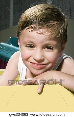 Portrait of a boy in a toy car and smiling View Large Photo Image Stock Image - Portrait of a boy in a toy car and smiling. Fotosearch