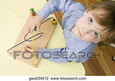 Portrait of a boy playing with a toy View Large Photo Image Stock Image - Portrait of a boy playing with a toy. Fotosearch