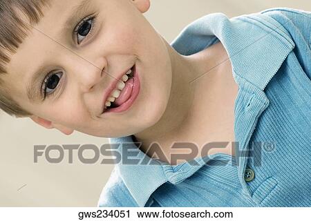 Portrait of a boy sticking his tongue out View Large Photo Image Stock Image - Portrait of a boy sticking his tongue out. Fotosearch