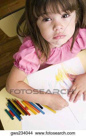 Portrait of a girl drawing on a sheet of paper View Large Photo Image Picture - Portrait of a girl drawing on a sheet of paper. Fotosearch