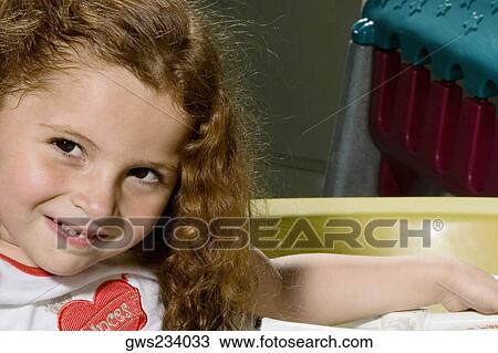 Portrait of a girl in a toy car and smiling View Large Photo Image Stock Image - Portrait of a girl in a toy car and smiling. Fotosearch