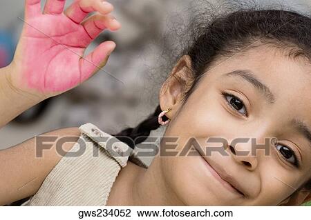 Portrait of a girl showing paint covered hand and smiling View Large Photo Image Stock Image - Portrait of a girl showing paint covered hand and smiling. Fotosearch
