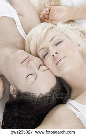 Close-up of a female homosexual couple lying on the bed View Large Photo Image Stock Photo - Close-up of a female homosexual couple lying on the bed. Fotosearch