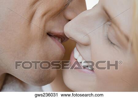 Stock Image - Close-up of a young couple kissing each other. Fotosearch