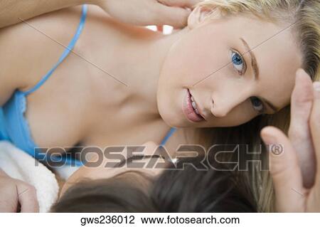 Close-up of a young couple romancing View Large Photo Image Stock Image - Close-up of a young couple romancing. Fotosearch