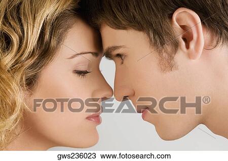 Close-up of a young couple romancing View Large Photo Image Stock Image - Close-up of a young couple romancing. Fotosearch