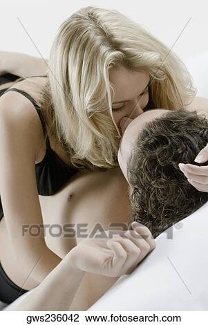 Close-up of a young couple romancing View Large Photo Image Stock Image - Close-up of a young couple romancing. Fotosearch
