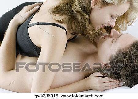 Stock Photograph - Close-up of a young couple romancing. Fotosearch