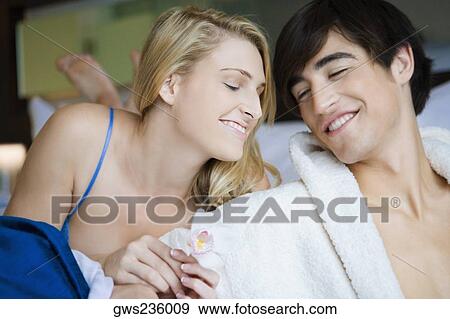 Stock Photo - Close-up of a young couple smiling. Fotosearch