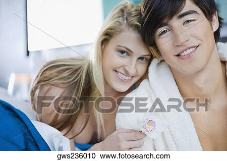 Stock Image - Portrait of a young couple smiling. Fotosearch