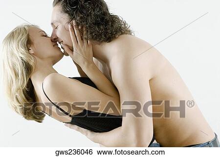 Side profile of a young couple romancing View Large Photo Image Stock Photograph - Side profile of a young couple romancing. Fotosearch