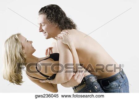 Side profile of a young couple romancing View Large Photo Image Stock Photography - Side profile of a young couple romancing. Fotosearch