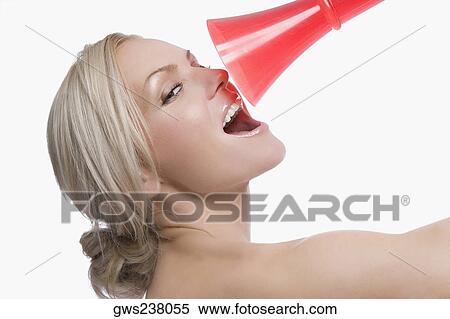Stock Photography - Close-up of a young woman holding a megaphone in front of her face. Fotosearch