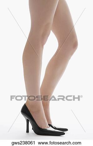 Low section view of a young woman standing View Large Photo Image Stock Image - Low section view of a young woman standing. Fotosearch