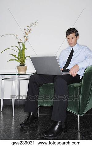 Businessman using a laptop View Large Photo Image Stock Image - Businessman using a laptop. Fotosearch