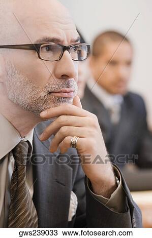 Close-up of a businessman thinking View Large Photo Image Stock Image - Close-up of a businessman thinking. Fotosearch