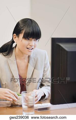 Close-up of a businesswoman looking at a computer monitor View Large Photo Image Stock Photograph - Close-up of a businesswoman looking at a computer monitor. Fotosearch