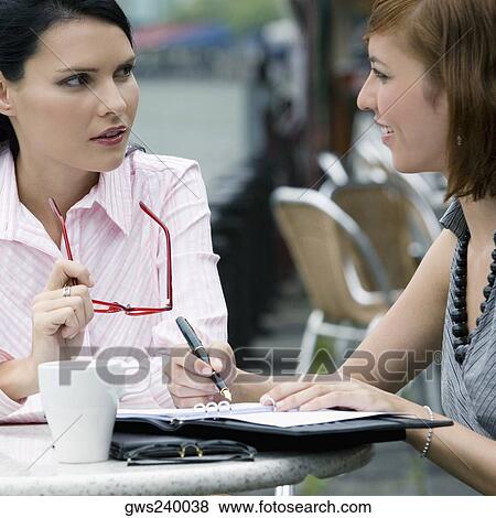 Close-up of two businesswomen having a discussion View Large Photo Image Stock Photo - Close-up of two businesswomen having a discussion. Fotosearch