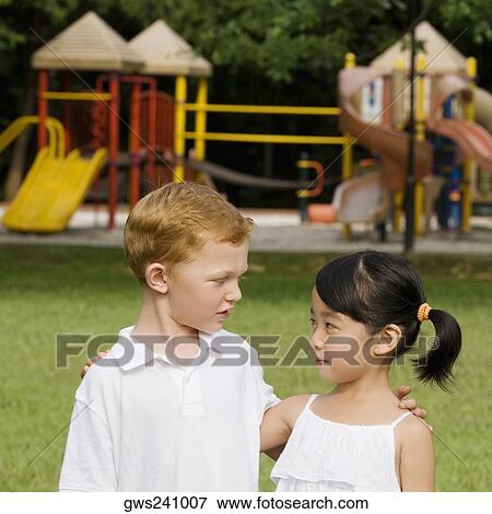 Close-up of a boy and a girl looking at each other View Large Photo Image Stock Photo - Close-up of a boy and a girl looking at each other. Fotosearch
