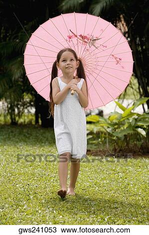 Girl walking in a park with an umbrella View Large Photo Image Stock Image - Girl walking in a park with an umbrella. Fotosearch